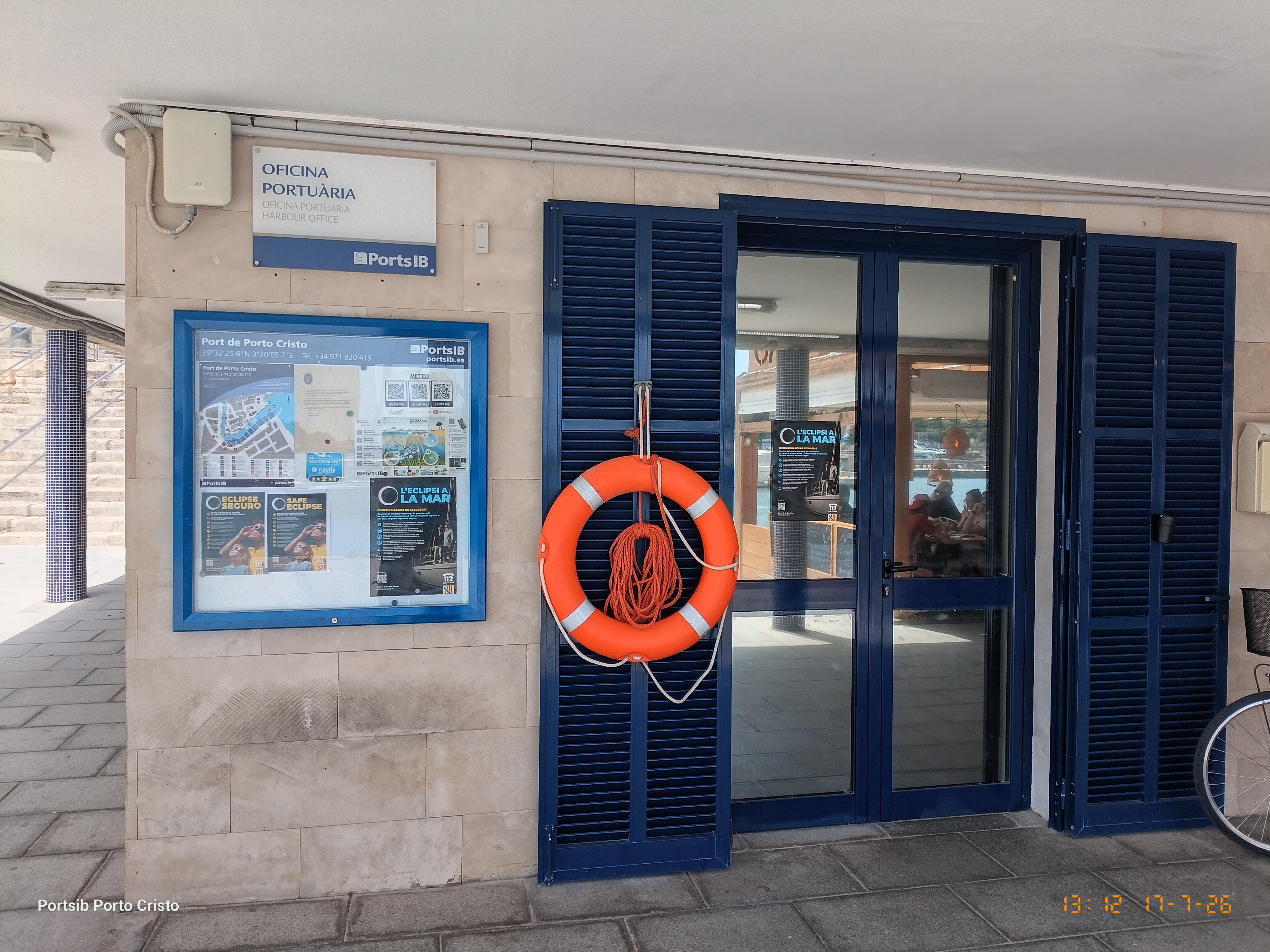 Entrada d'una oficina portuària amb cartells d'eclipsi segur a la seva façana